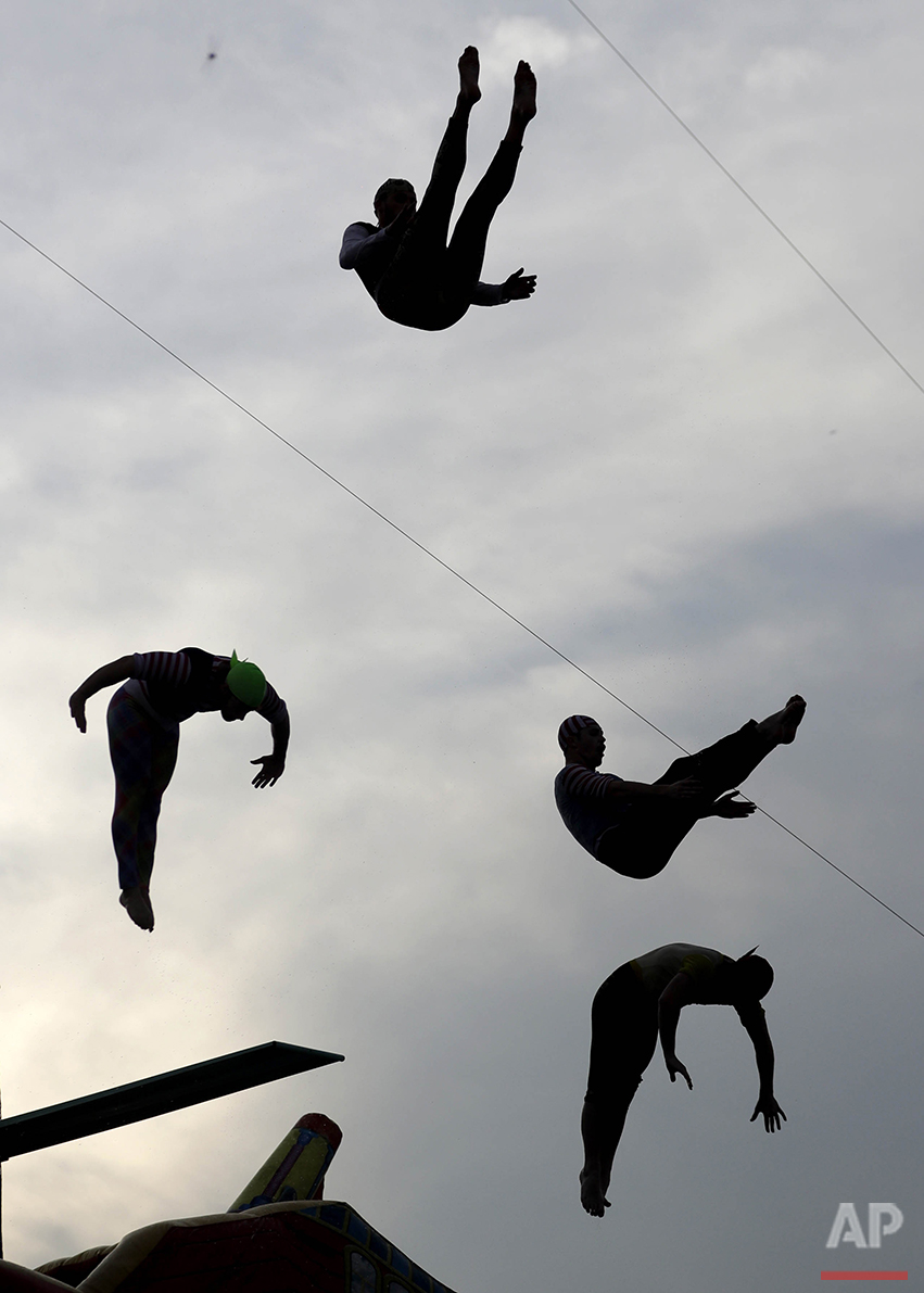  Divers jump into a 9.5-foot pool during a performance by the Sinbad High Dive Show at the State Fair Meadowlands carnival in East Rutherford, N.J., Thursday, July 7, 2016. (AP Photo/Julio Cortez) 