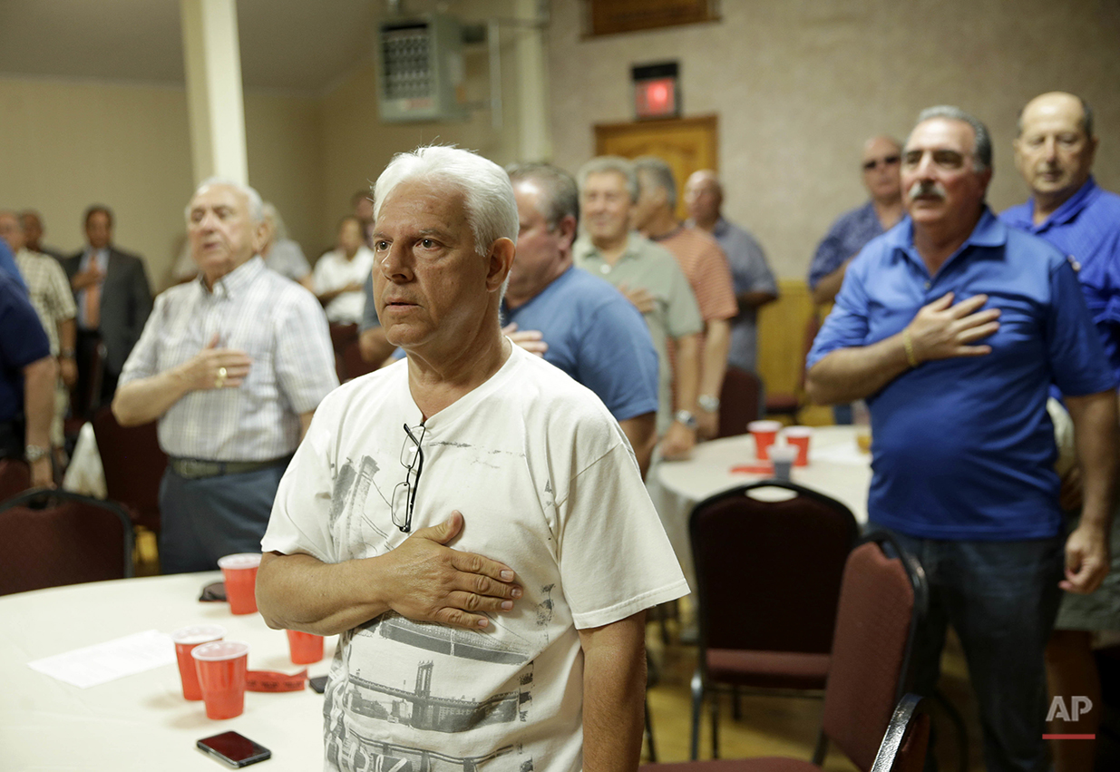  Members of the NYC Verrazano 10-13 Association, made up of retired police officers, say the Pledge of Allegiance during a meeting in the Staten Island borough of New York, Wednesday, June 15, 2016. One of the members can trace policing lineage from 