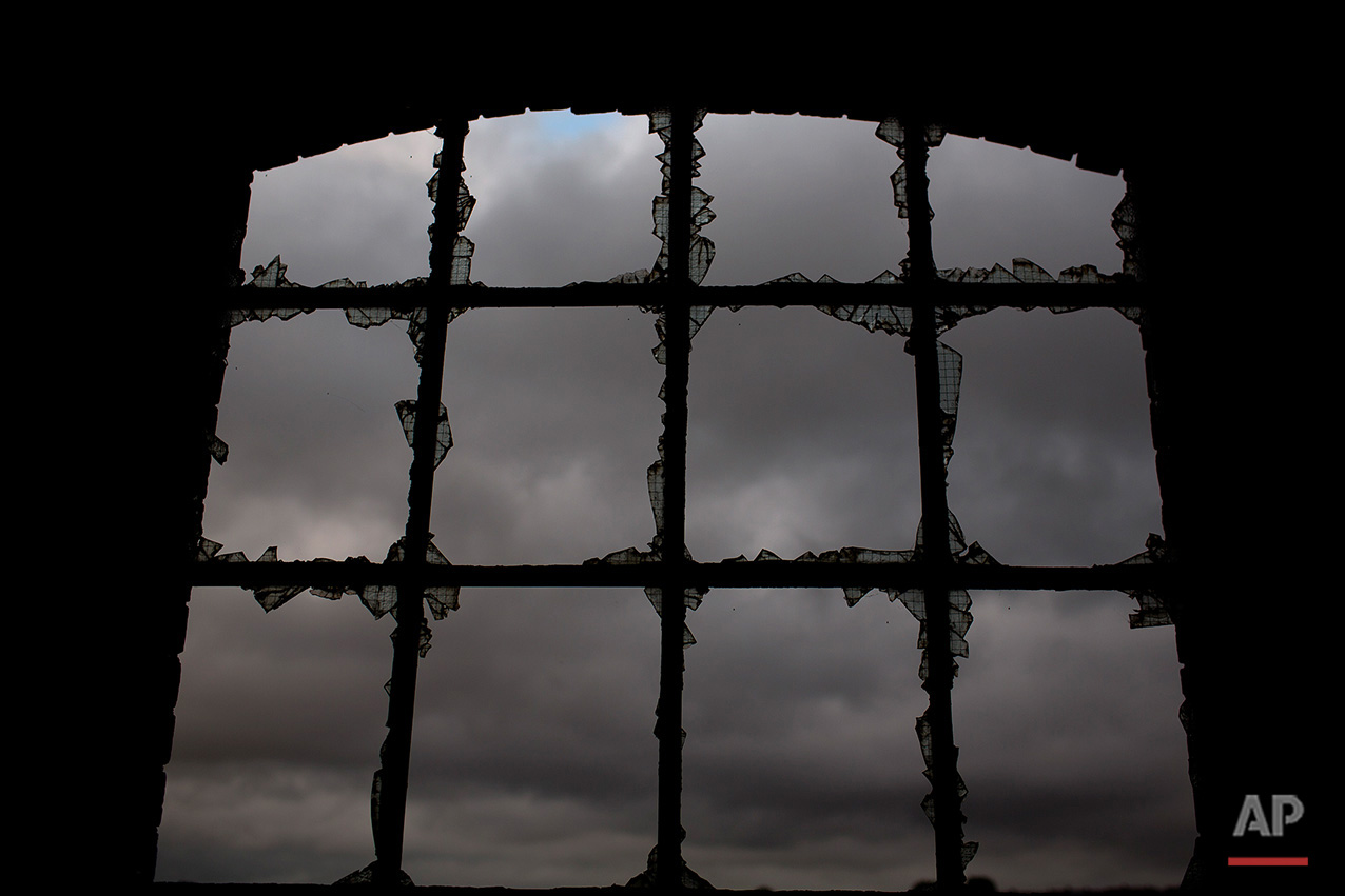  In this Thursday, June 30, 2016 photo, a cloudy sky is seen through the broken glasses of a window, inside the workshop building of the Penallta colliery in Hengoed, South Wales.  (AP Photo/Emilio Morenatti)

 