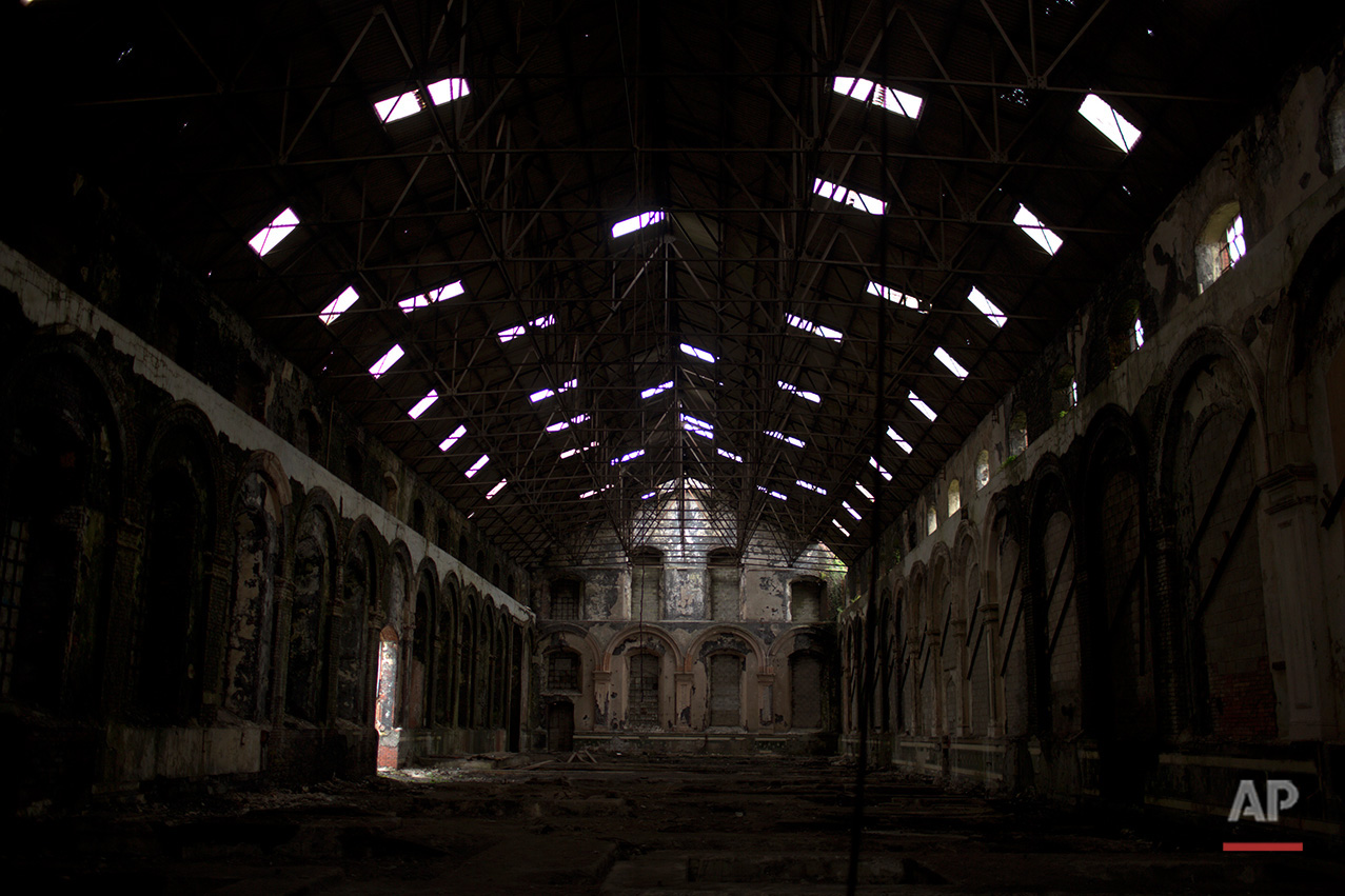  In this Thursday, June 30, 2016 photo, light enters through the holes of the roof of the abandoned and looted workshop building at the Penallta colliery in Hengoed, South Wales.  (AP Photo/Emilio Morenatti)

 