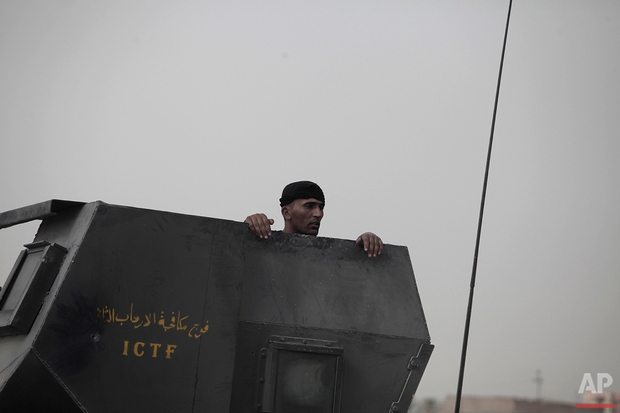  A soldier with Iraq's elite counterterrorism forces peers from the gun turret of a Humvee on the front line in Fallujah, Iraq, Sunday, June 5, 2016. Iraqi forces are pushing their way into the city to retake it from Islamic State militants. (AP Phot