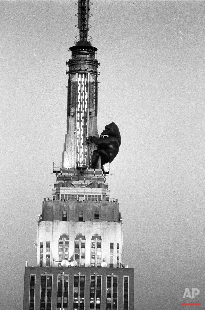  As day turns to dusk in New York City, an 84-foot balloon of King Kong clings to the top of the Empire State Building, April 13, 1983.  It was inflated by workmen from the Robert Keith Company of San Diego to celebrate the 50th anniversary of the or