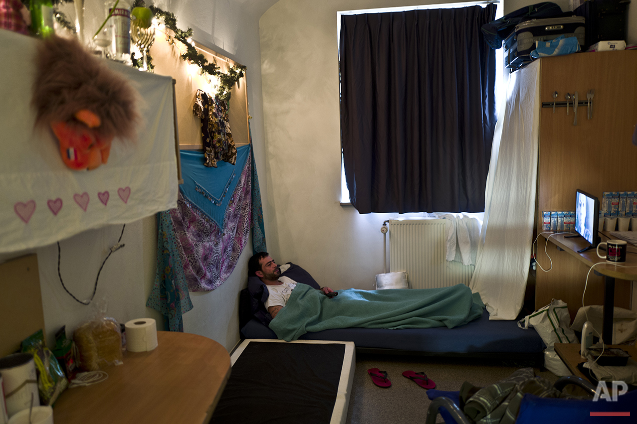  In this Friday, April 29, 2016 photo, Syrian refugee Alaa Mohammed, 35, watches TV in his room at the former prison of De Koepel in Haarlem, Netherlands. With crime declining in the Netherlands, the country is looking at new ways to fill its prisons