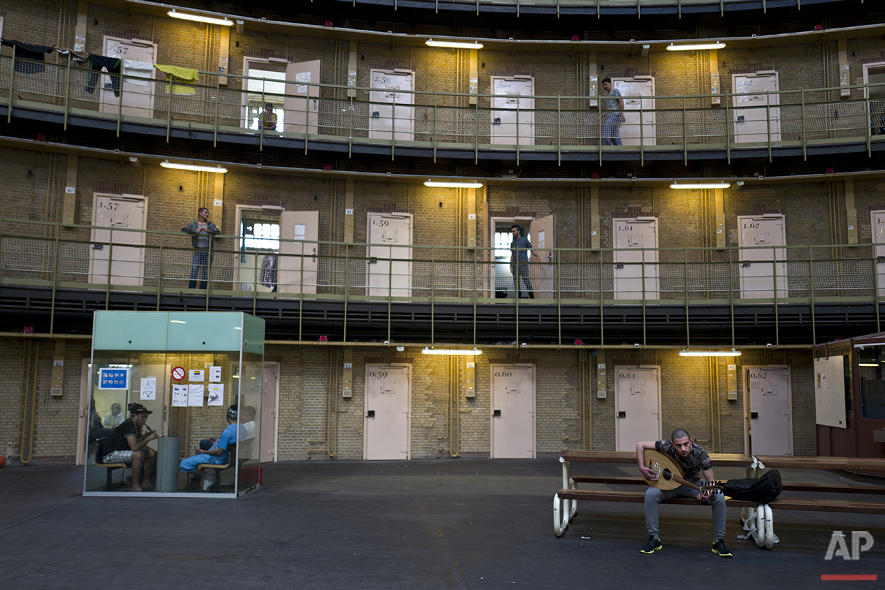  In this Thursday, April 21, 2016 photo, Syrian refugee Fadi Tahhan, 23, right, sings while playing Oud at the former prison of De Koepel in Haarlem, Netherlands. (AP Photo/Muhammed Muheisen) 