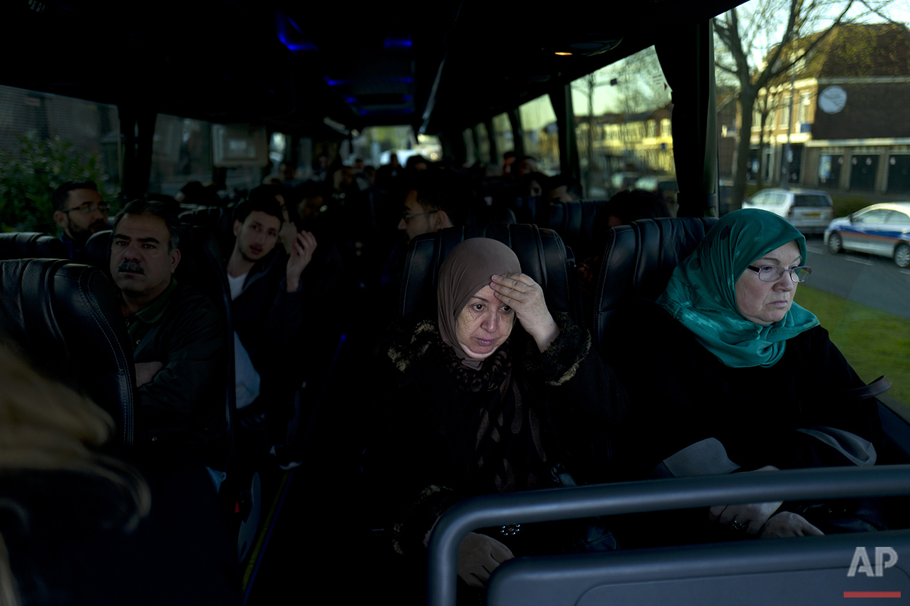  In this Friday, May 6, 2016 photo, Iraqi refugee Fatima Hussein, 65, reacts while she and others wait in a bus heading to have a government interview for their asylum seeking process outside the former prison of De Koepel in Haarlem, Netherlands. (A