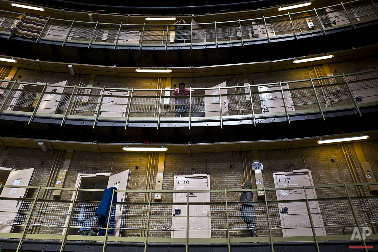  In this Sunday, May 1, 2016 photo, an Afghan refugee man, center, listens to another Afghan refugee at the former prison of De Koepel in Haarlem, Netherlands. (AP Photo/Muhammed Muheisen) 