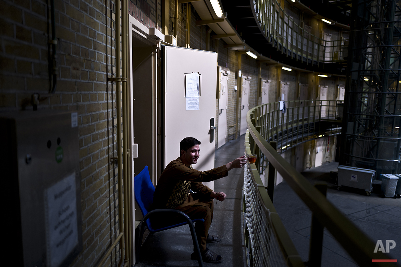  In this Sunday, May 1, 2016 photo, Afghan refugee Siratullah Hayatullah, 23, drinks tea by the doorway of his room at the former prison of De Koepel in Haarlem, Netherlands. (AP Photo/Muhammed Muheisen) 