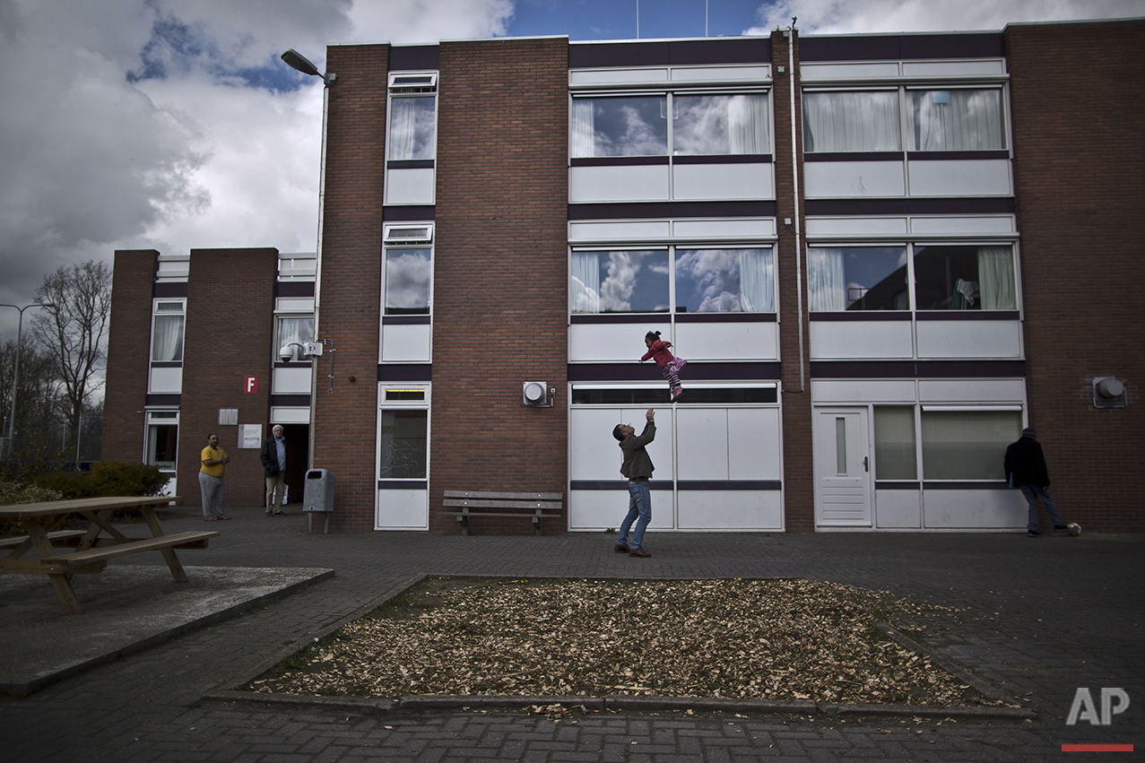  In this Friday, April 8, 2016 photo, a migrant plays with a girl at the former prison of Westlingen in Heerhugowaard northwestern Netherlands. (AP Photo/Muhammed Muheisen) 