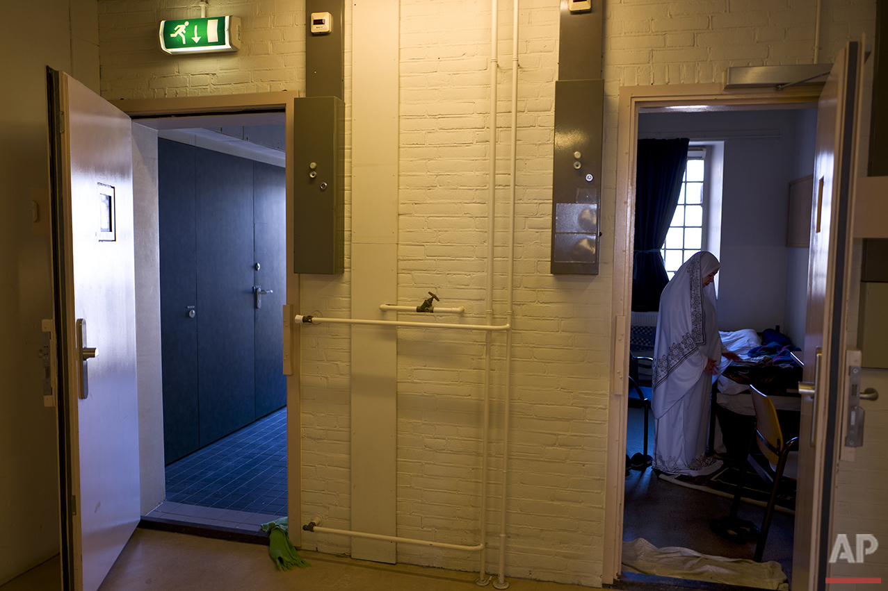  In this Wednesday, April 20, 2016 photo, Iraqi refugee Fatima Hussein, 65, prays inside her room at the former prison of De Koepel in Haarlem, Netherlands. (AP Photo/Muhammed Muheisen) 