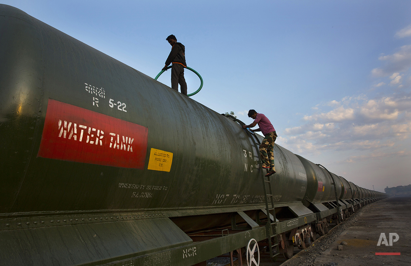  In this May 9, 2016, photo, workers fill a water tank on the Jaldoot water train at the Miraj railway station, Miraj, 340 kilometers (211 miles) from Latur, in the Indian state of Maharashtra. Many trains pull into Latur's railroad station but none 