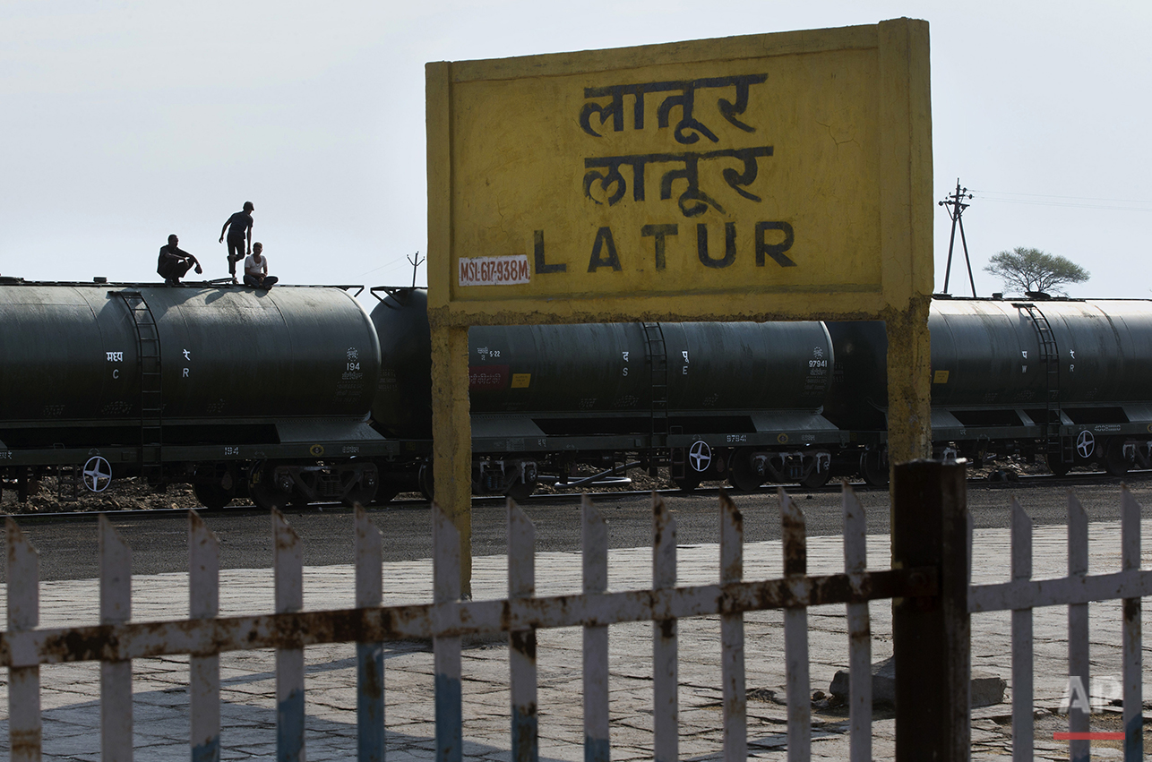  In this May 10, 2016, photo, workers sit on the top of a tanker carriage after unloading the water from the Jaldoot water train at the Latur railway station, in the Indian state of Maharashtra. Many trains pull into Latur's railroad station but none