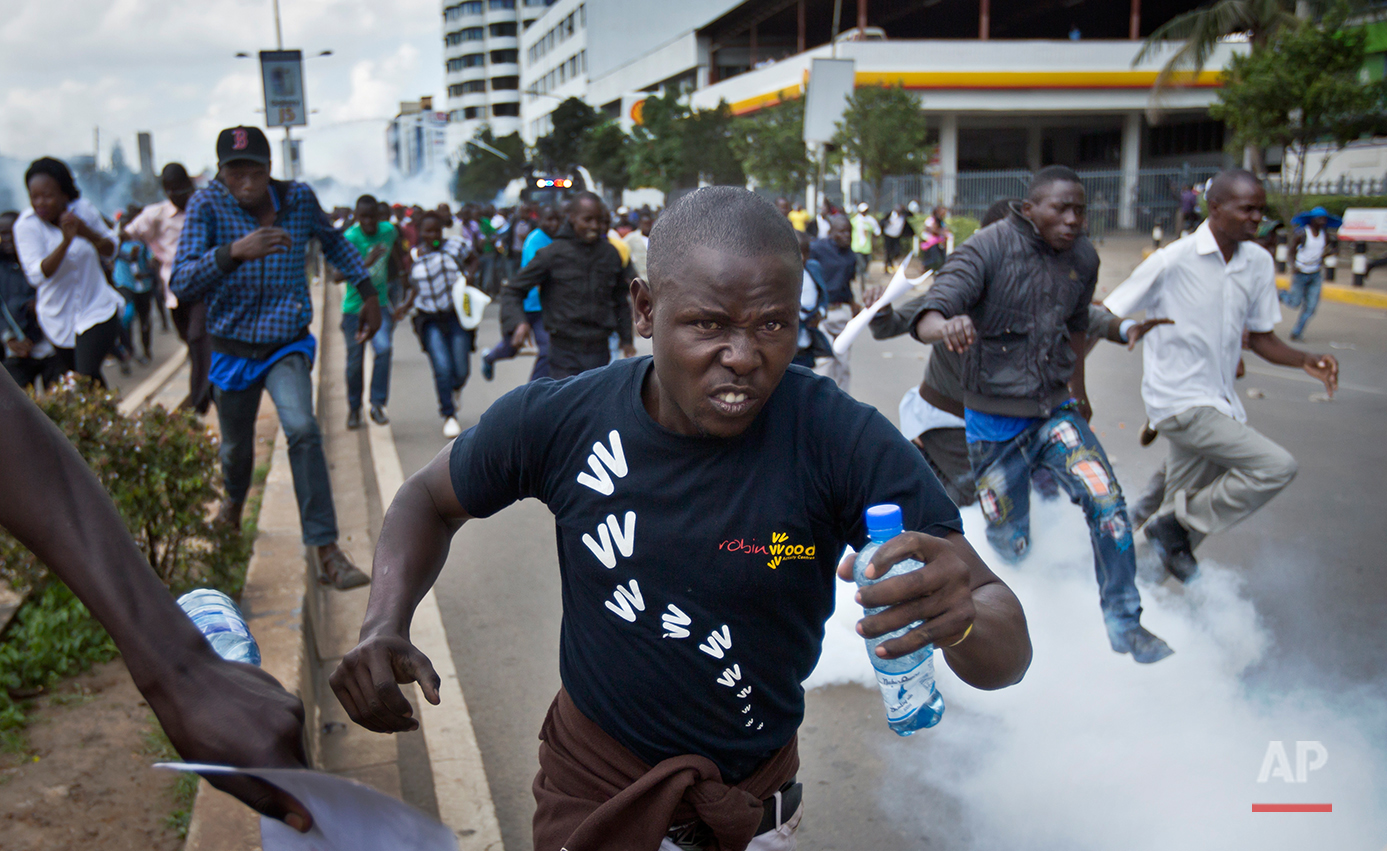  Opposition supporters flee from tear gas grenades fired by riot police, during a protest in downtown Nairobi, Kenya Monday, May 16, 2016. Kenyan police have tear-gassed and beaten opposition supporters during a protest demanding the disbandment of t