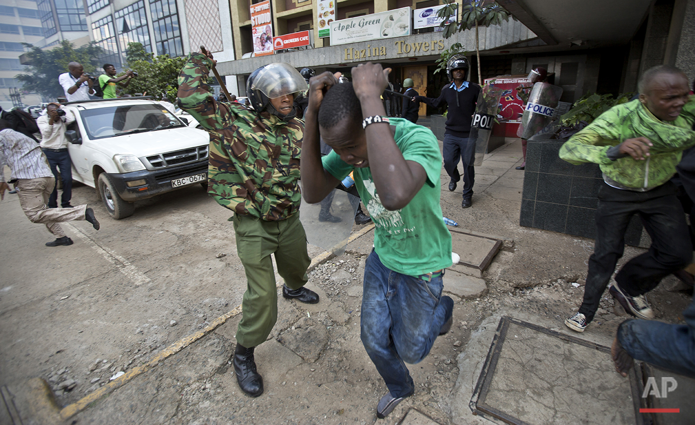  Opposition supporters are beaten with wooden clubs by riot police as they try to flee, during a protest in downtown Nairobi, Kenya Monday, May 16, 2016. Kenyan police have tear-gassed and beaten opposition supporters during a protest demanding the d