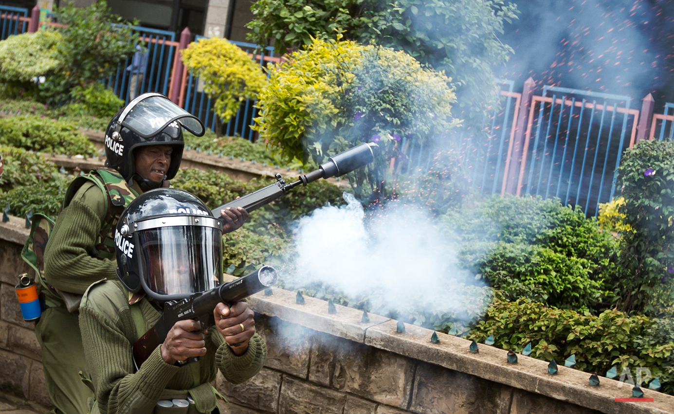  Kenyan police fire tear gas to disperse a small group of opposition protesters who tried to gather outside the offices of the electoral commission, in downtown Nairobi, Kenya Monday, May 23, 2016. Kenya's police shot, beat and tear gassed opposition