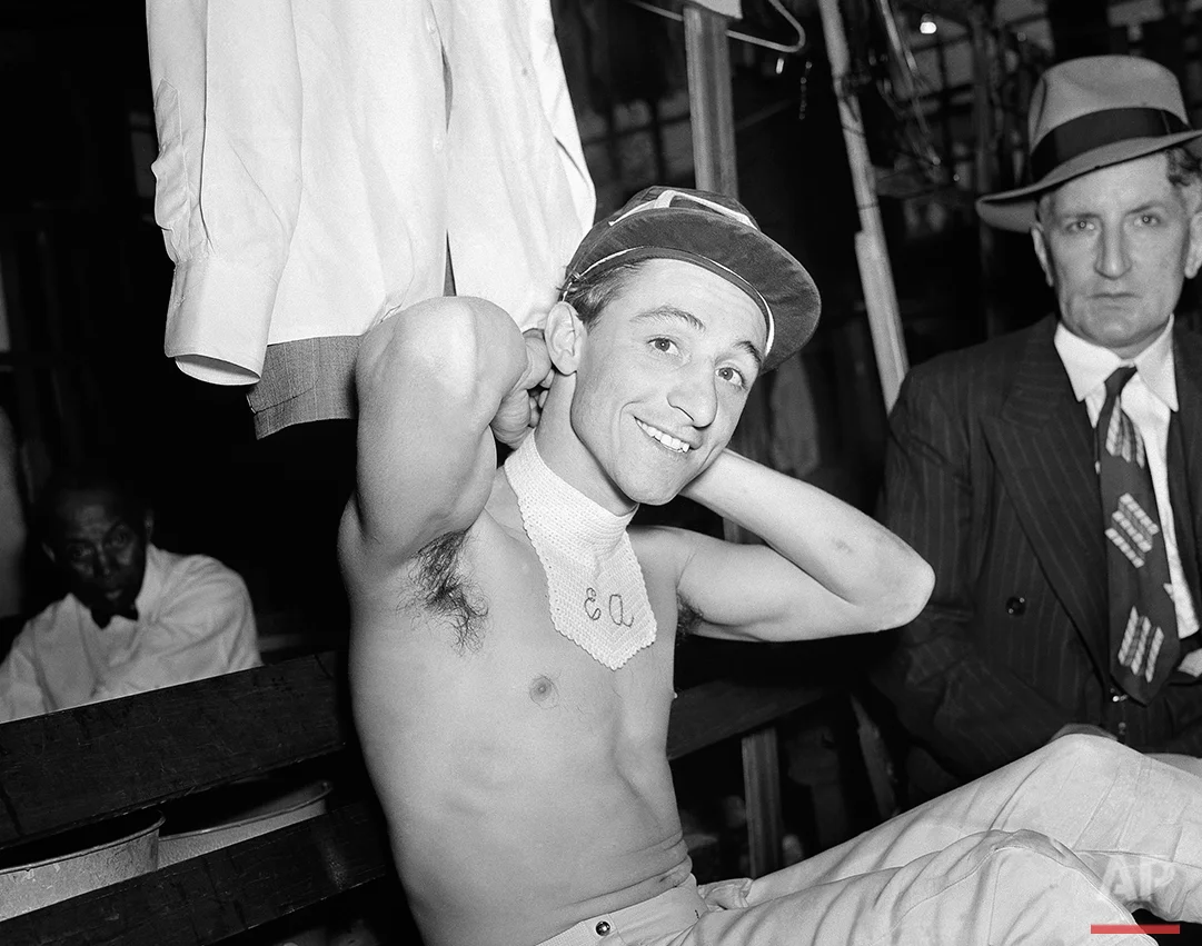 Eddie Arcaro washes his face in a bucket of water after riding Whirlaway to victory in the Kentucky Derby in Louisville, Ky., May 3, 1941. (AP Photo)