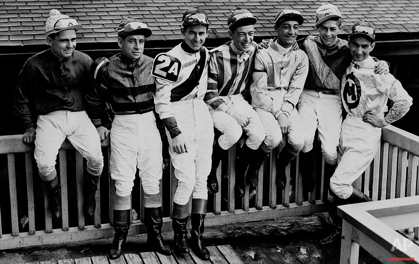 Seven of the jockeys scheduled to ride in today's Kentucky Derby sit on the rail at Churchill Downs after taking part in yesterday's Kentucky Oaks. Left to right, with horses they'll ride: Steve Brooks, Star Reward; Johny Longden, on trust; Eric Guerin, Jet Pilot; Shelby Clark, Cosmic Bomb; Eddie Arcaro, Phalanx; Job Jessop, Liberty road, and Will Balzaretti, Riskolater. (AP Photo)