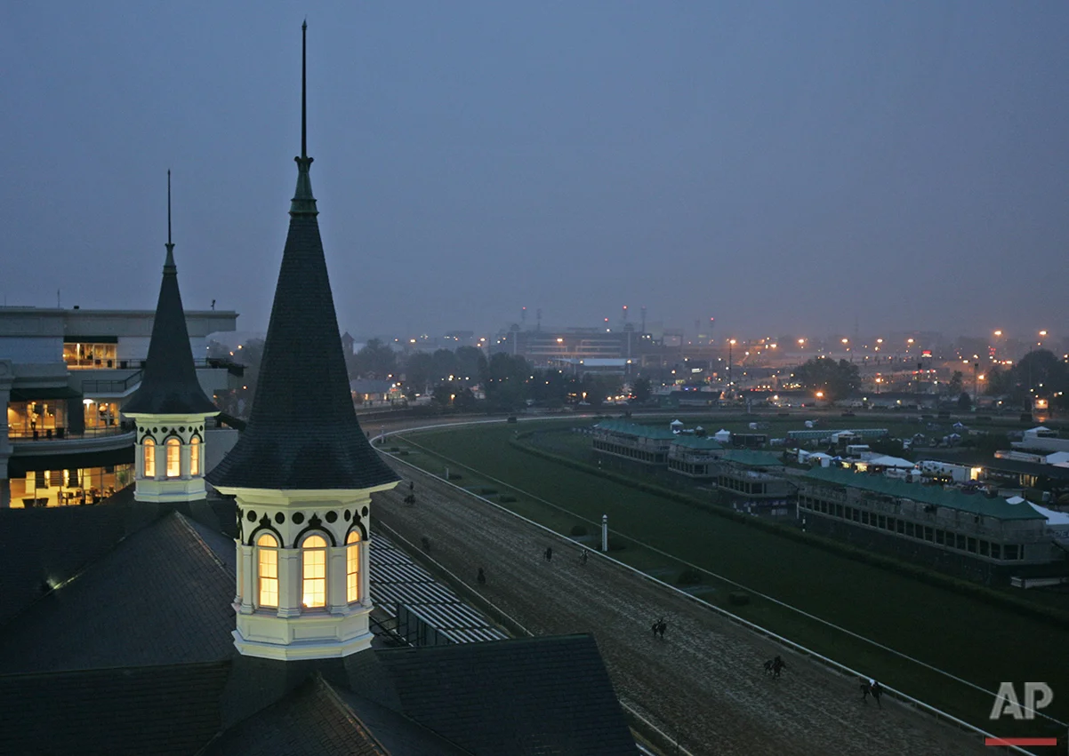 Horses run past the Churchill Downs spires in Louisville, Ky., Friday, May 4, 2007. (AP Photo/Darron Cummings)