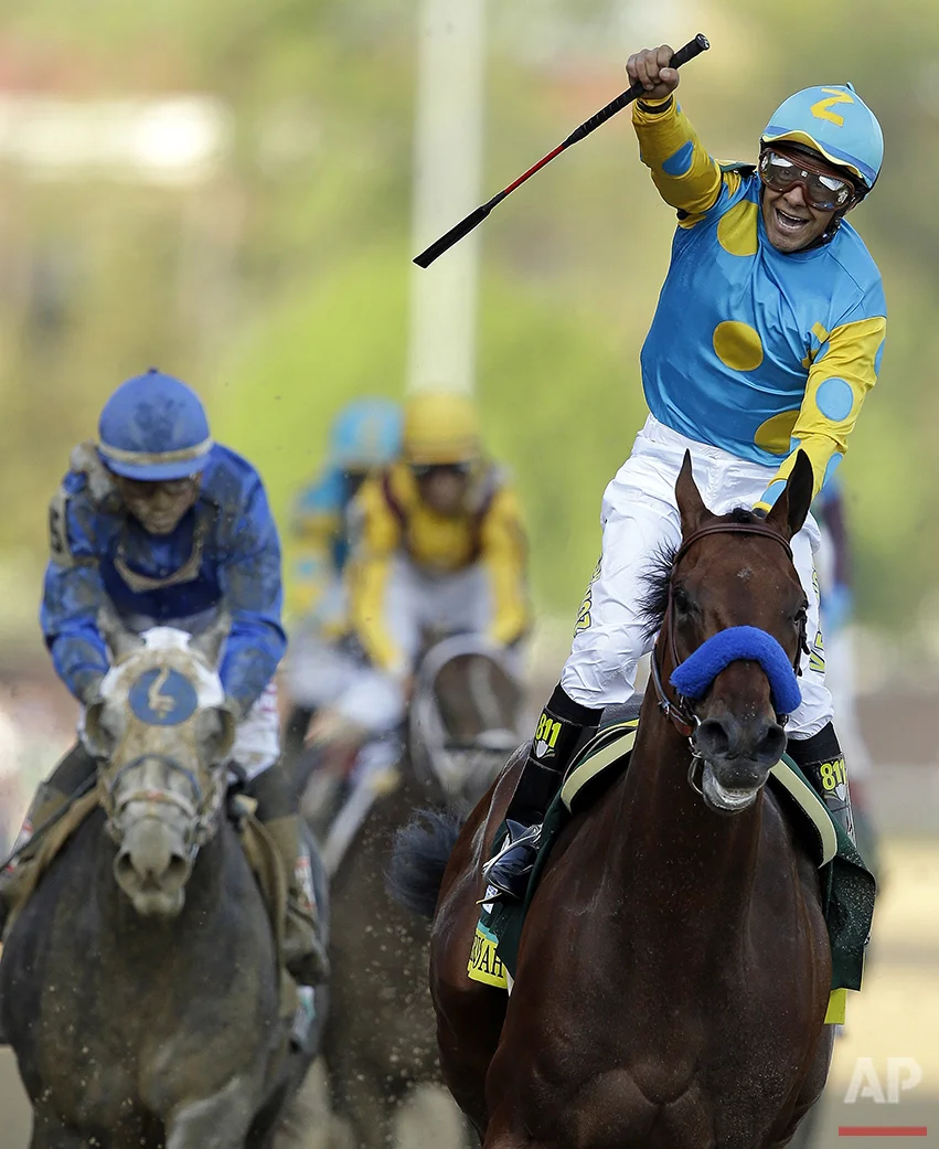 In this Saturday, May 2, 2015, photo, jockey Victor Espinoza celebrate atop American Pharoah after they won the Kentucky Derby horse race at Churchill Downs in Louisville, Ky. (AP Photo/Darron Cummings)