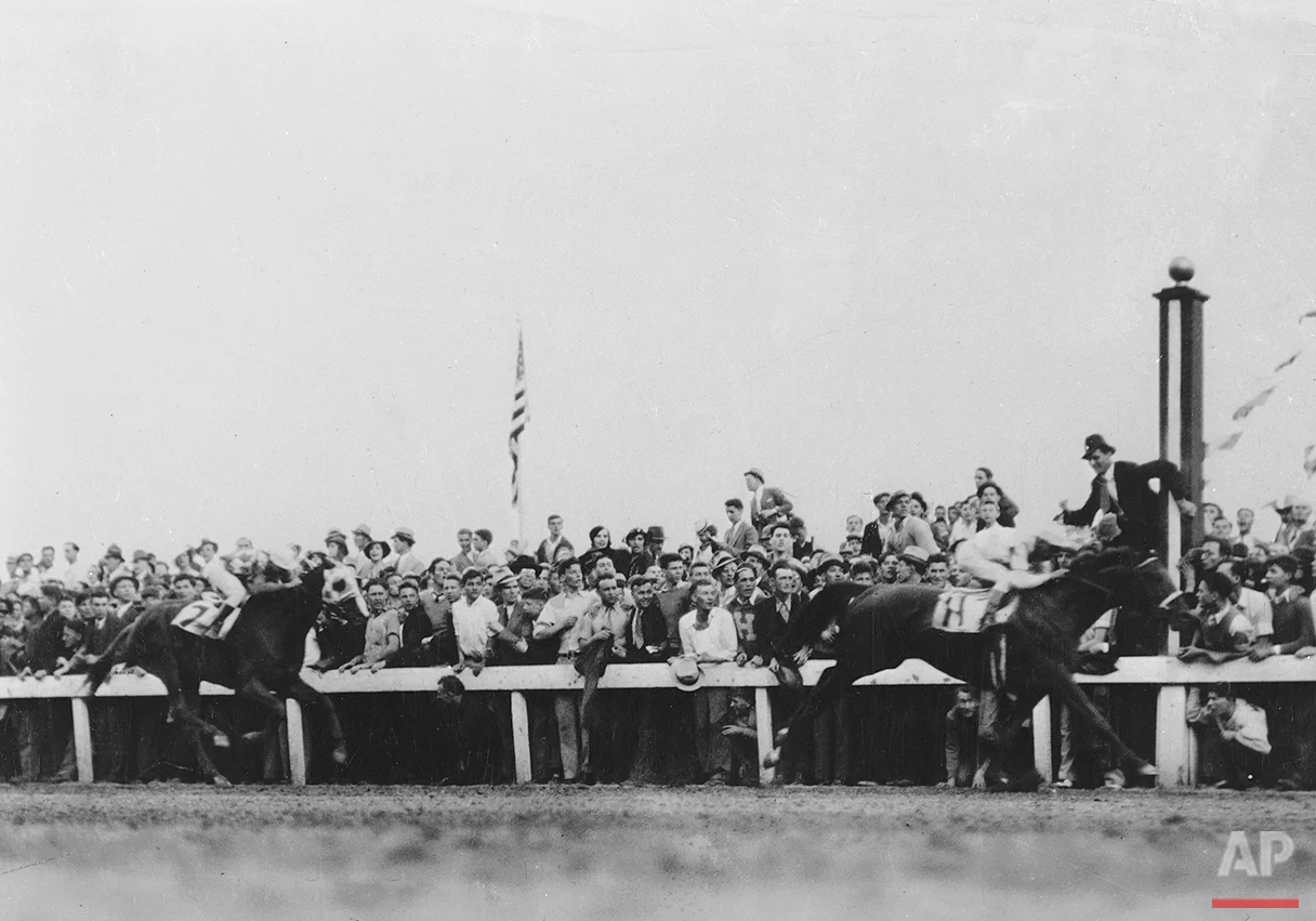 Crossing the finish line at the Kentucky Derby is Cavalcade and jockey Mack Garner, with Discovery in second place with rider John Bejshak coming up behind him, at Churchill Downs in Louisville, Ky., May 5, 1934. (AP Photo)