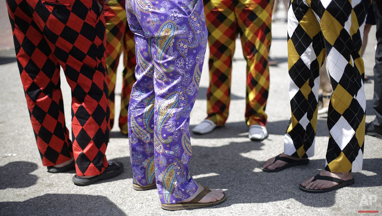 Spectators wear colorful pants before the 140th running of the Kentucky Derby horse race at Churchill Downs, Saturday, May 3, 2014, in Louisville, Ky. (AP Photo/David Goldman)