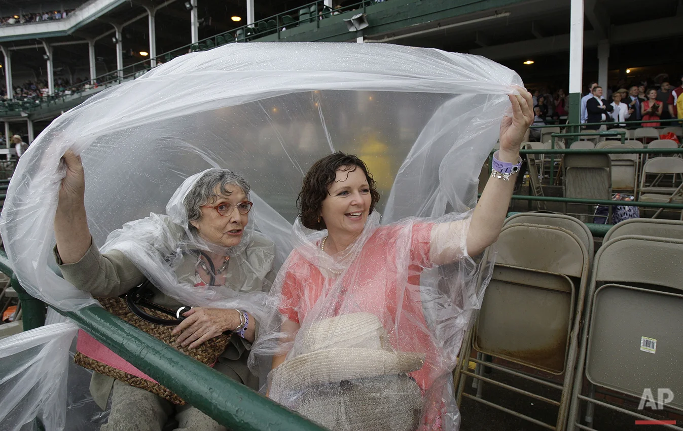 Jean McKierman, left, and Charlotte Wilson, of Hot Springs, Ark., watch the sixth race at Churchill Downs Friday, May 2, 2008, in Louisville, Ky. (AP Photo/Darron Cummings)