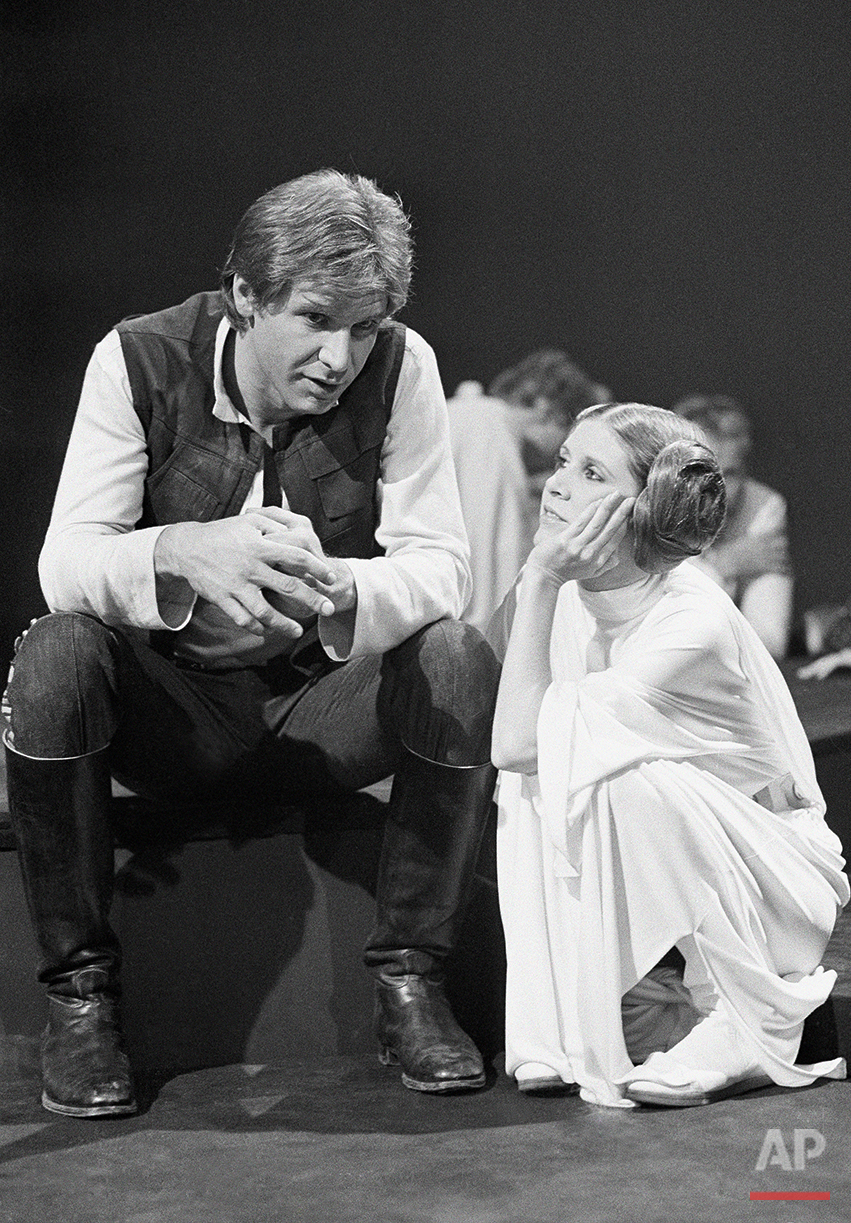  Harrison Ford, as Han Solo of “Star Wars” fame chats with Carrie Fisher Nov. 13, 1978 during a break in the filming of the CBS-TV special “The Star Wars Holiday.” Ford says he leaves the singing in the special to Carrie, who is the daughter of Eddie