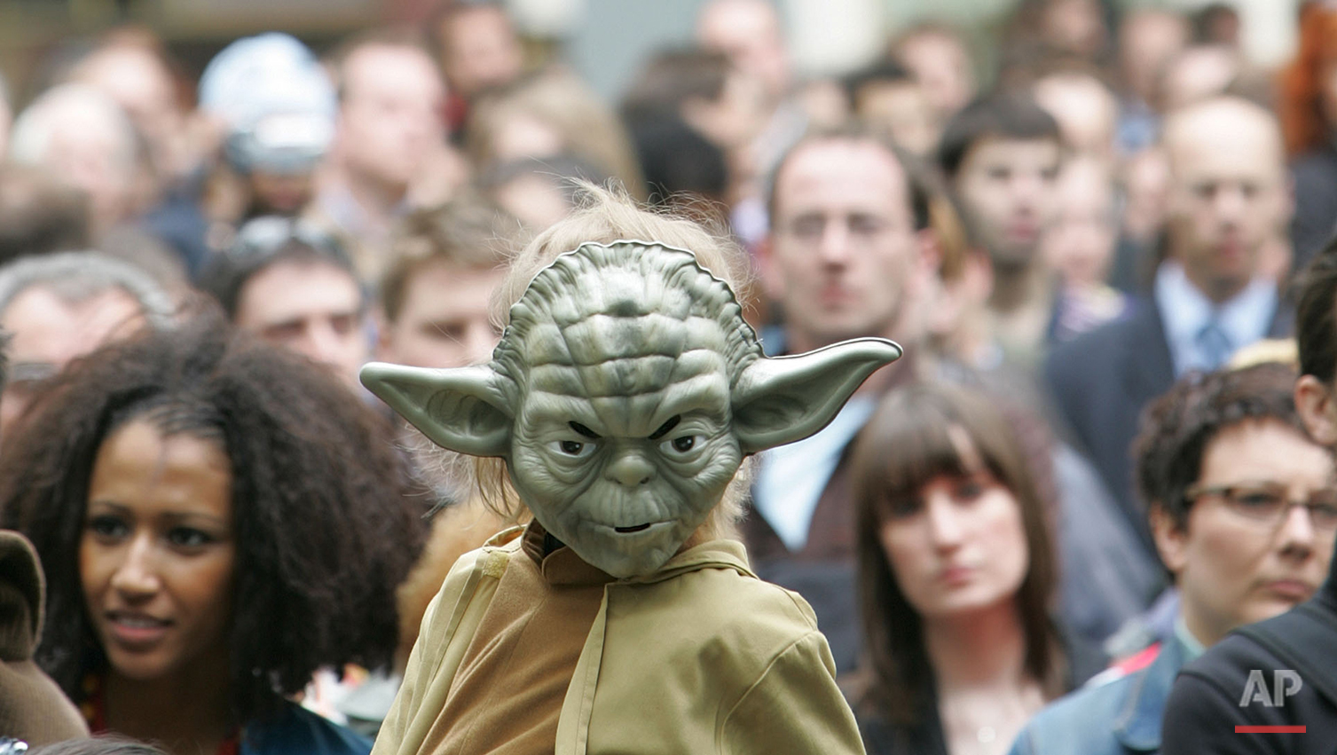  A young boy dressed as the Star Wars character 'Yoda' sits on the shoulders of a man as he watches events in Leicester Square in London and joins in with the premier launch of the film Star Wars Episode III Revenge of the Sith,  Monday May 16, 2005.