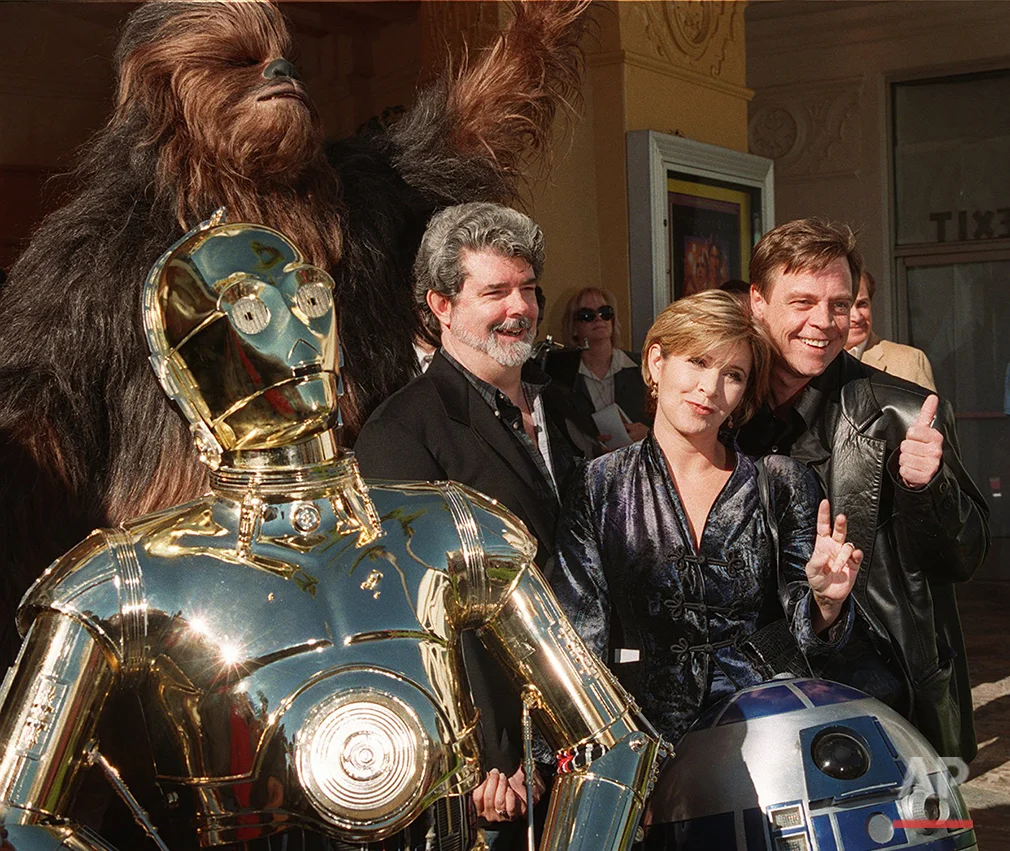 Characters from the film "Star Wars" join writer and director George Lucas, left, Carrie Fisher, center, and Mark Hamill at the world premiere of "Star Wars Special Edition" Saturday, Jan. 18, 1997, in the Westwood section of Los Angeles. The movie was first released 20 years ago. (AP Photo/Rene Macura)
