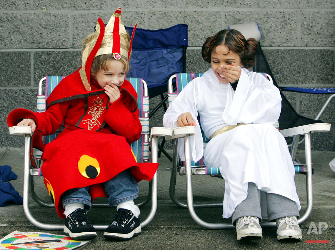  Aurora Olayos, left, 6, dressed as Queen Amidala, shares a laugh with sister Ariel Olayos, 9, right, dressed as Princess Leia, as they sit outside the Lloyd Cinemas waiting for the opening of "Star Wars: The Revenge of the Sith" in Portland, Ore., W
