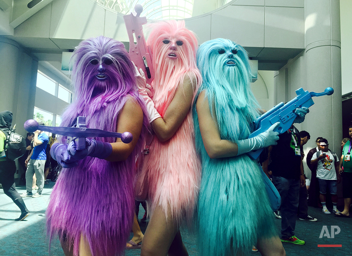  In this July 10, 2015 photo, fans dressed as "Chewie's Angels" attend day 2 of Comic-Con International, in San Diego, Calif. Star Wars” inspires curiously personal reactions. It drives some people to don Wookie costumes and others to curse an entire