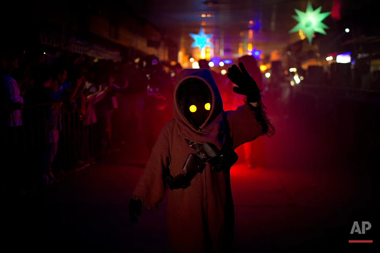 In this Feb. 14, 2016 photo, a youth sporting a Star Wars costume parades at the annual Alien Festival in Capilla del Monte, Cordoba, Argentina, the site of an alleged UFO sighting 30 years ago. Thousands of earthlings gathered for the festival in this central Argentine town which has become a global hot spot for UFO sightings. (AP Photo/Natacha Pisarenko)