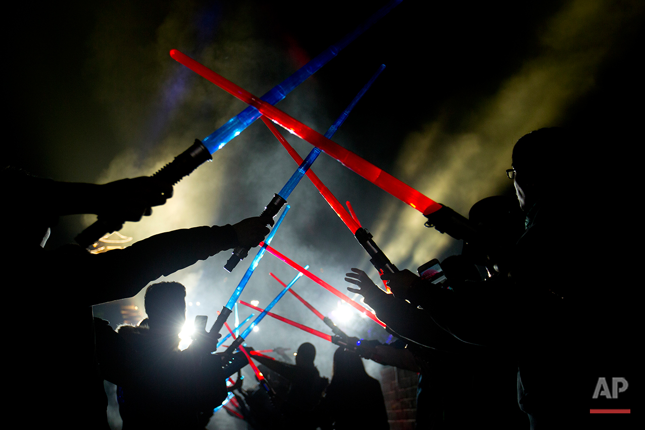  Chinese Star Wars fans hold light sabers at they pose for a group photo during a promotional event for the movie "Star Wars: The Force Awakens" at the Juyongguan section of the Great Wall of China near Beijing, Tuesday, Oct. 20, 2015. The film, the 