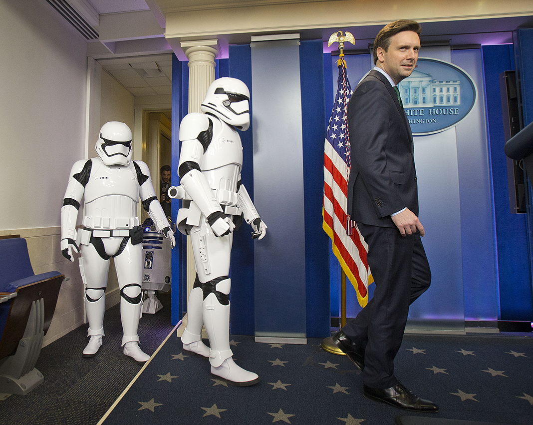  White House Press secretary Josh Earnest is joined by Star Wars Storm Troopers and R2D2 in the Brady Press Briefing Room of the White House, Friday, Dec. 18, 2015. The movie characters will greet children of Gold Star families who are attending a sp