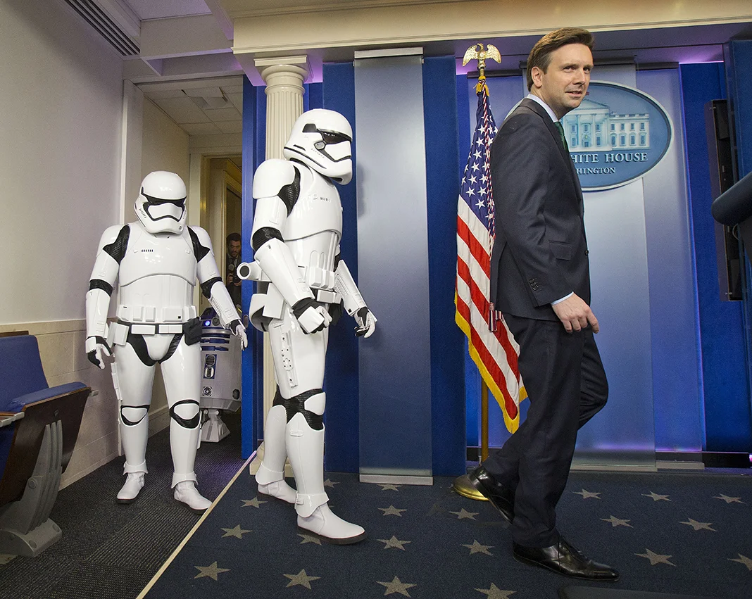 White House Press secretary Josh Earnest is joined by Star Wars Storm Troopers and R2D2 in the Brady Press Briefing Room of the White House, Friday, Dec. 18, 2015. The movie characters will greet children of Gold Star families who are attending a special screening of Star Wars: The Force Awakens later today at the White House Family Theater. (AP Photo/Pablo Martinez Monsivais)