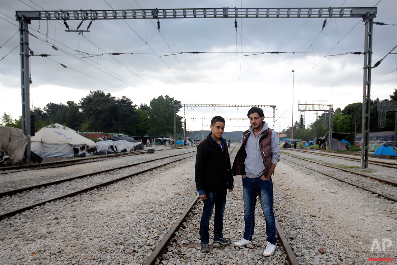  Syrians Mohammed Nur Sermini, left, and Mohammed Samir pose for a portrait on the tracks of a rail way station which was turned into a makeshift camp crowded by migrants and refugees at the northern Greek border point of Idomeni, Greece, Tuesday, Ma