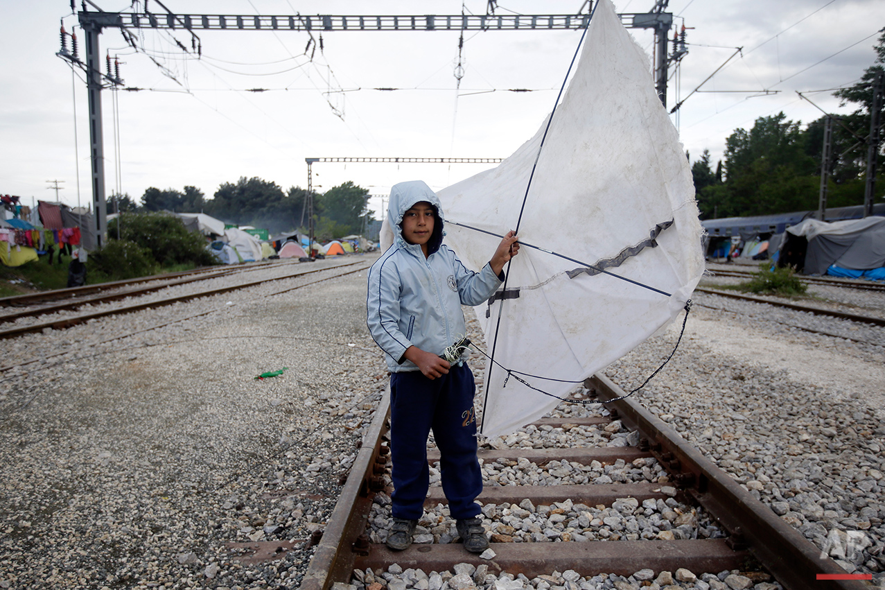  Yesa, 6, from Syria, holds his kite that he made with the sticks of a broken tent as he poses for a portrait on the tracks of a rail way station which was turned into a makeshift camp crowded by migrants and refugees at the northern Greek border poi