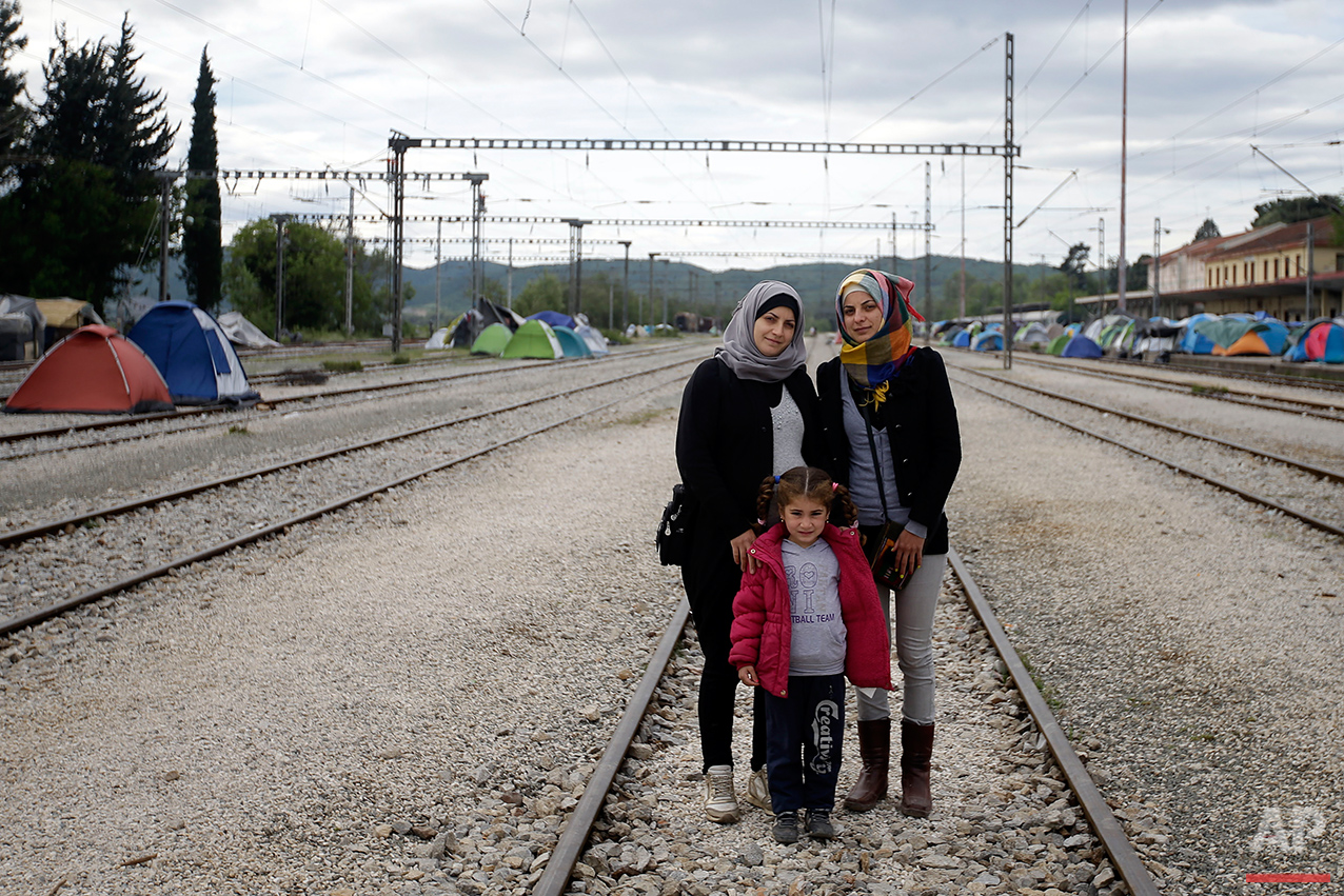  Syrian Magdolin Hameidi, left, poses for a portrait with her friend Juanin Ala, and her daughter Jana, 5 years old, on the tracks of a rail way station which was turned into a makeshift camp crowded by migrants and refugees at the northern Greek bor