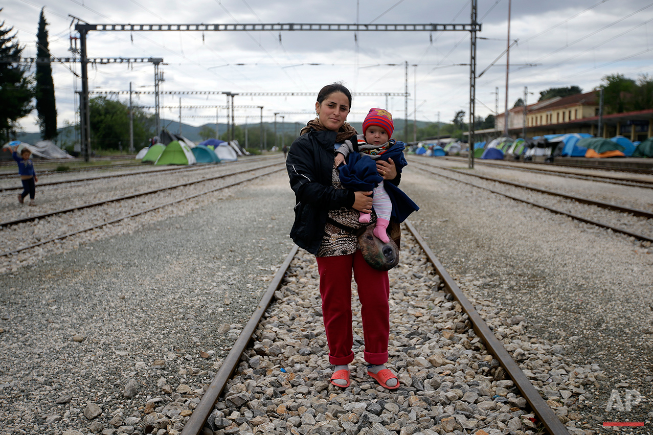  Diliber Kelesh from Syria, holds her 6-month-old baby Kamira as she poses for a portrait on the tracks of a rail way station which was turned into a makeshift camp crowded by migrants and refugees at the northern Greek border point of Idomeni, Greec