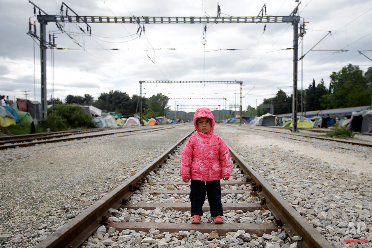  Lamal Alil, 3 years old, from Syria, poses for a portrait on the tracks of a rail way station which was turned into a makeshift camp crowded by migrants and refugees at the northern Greek border point of Idomeni, Greece, Tuesday, May 3, 2016.  (AP P