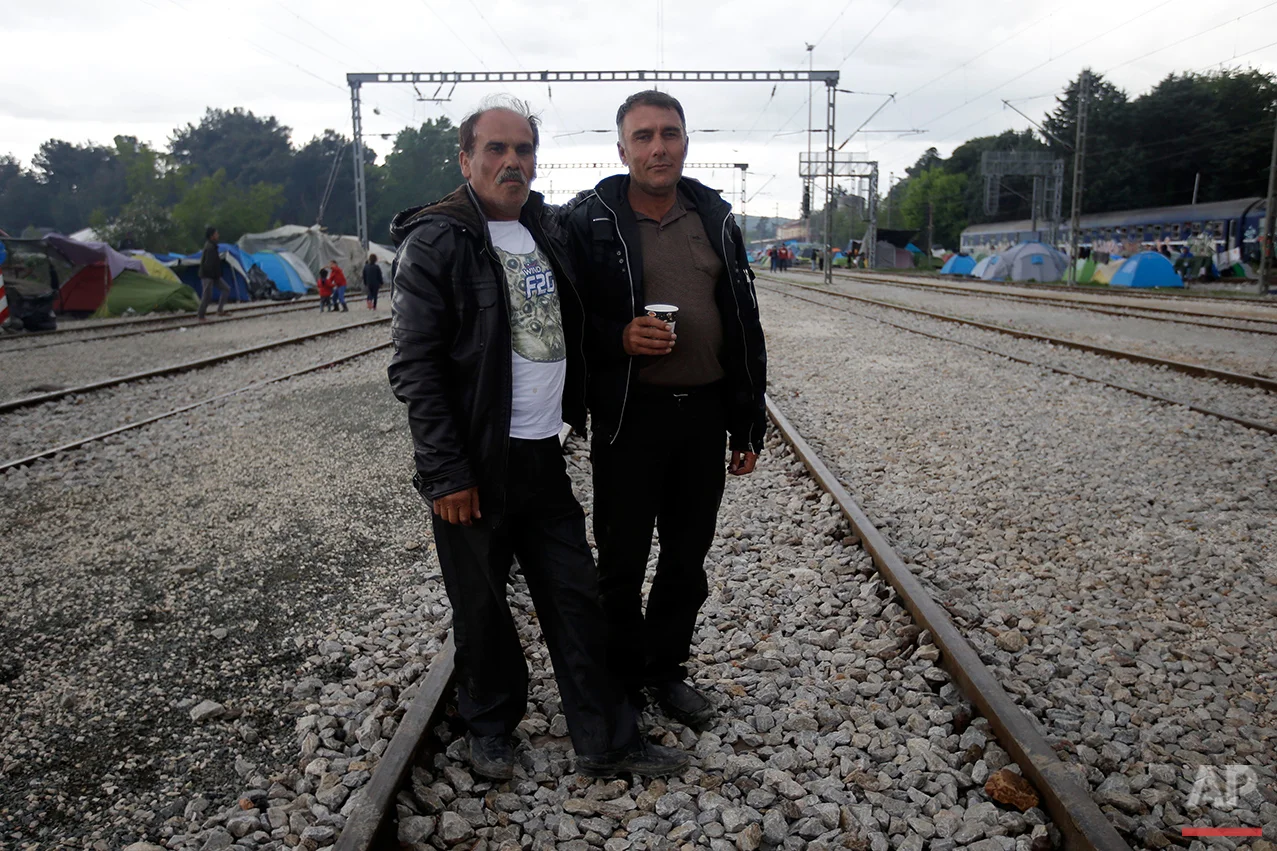 Syrians Murdin Mamou, left, and Mohammed Juma pose for a portrait on the tracks of a rail way station which was turned into a makeshift camp crowded by migrants and refugees at the northern Greek border point of Idomeni, Greece, Tuesday, May 3, 2016. At Greece’s blockaded border with Macedonia, 10,000 people who arrived hoping to start new lives farther west and north in Europe are settling instead into lives in limbo, sleeping in tents in mud and rain as they wait to find out what happens next. (AP Photo/Gregorio Borgia)