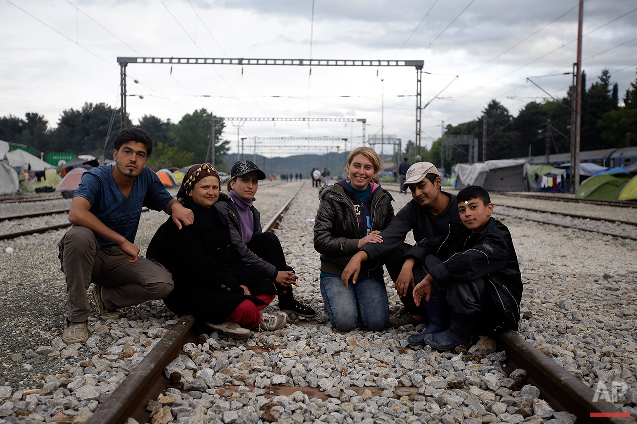  From left, Rashid Hassan, Waida Hassan, Evin Bilel, Neda Bilel, Hamud Hawar and Mohammed Arous, all from Syria, pose for a portrait on the tracks of a rail way station which was turned into a makeshift camp crowded by migrants and refugees at the no