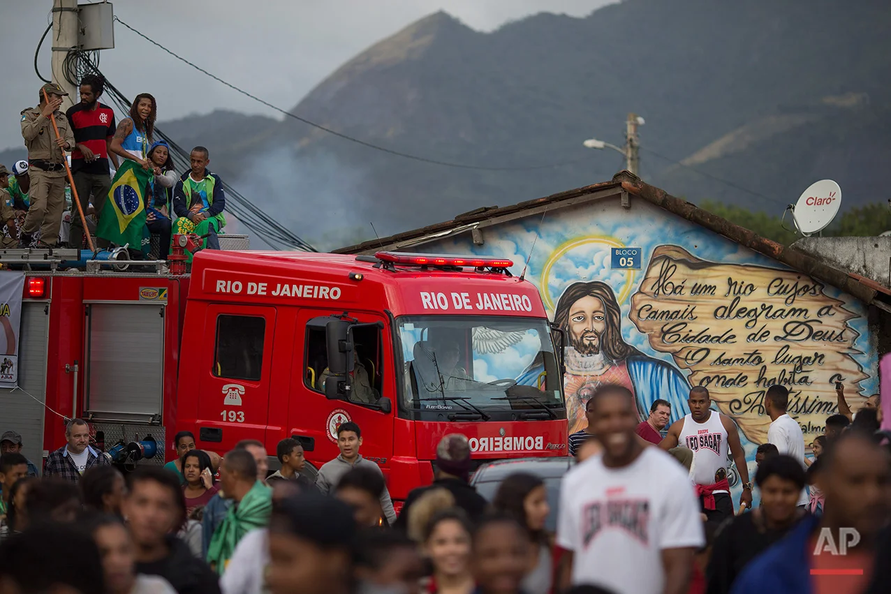  Brazilian Judo gold medalist Rafaela Silva is given a hero's welcome as she rides a fire truck into the Cidade de Deus "City of God" slum in Rio de Janeiro, Brazil, Monday, Aug. 22, 2016. Silva who grew up in the violent, poverty stricken slum, won 