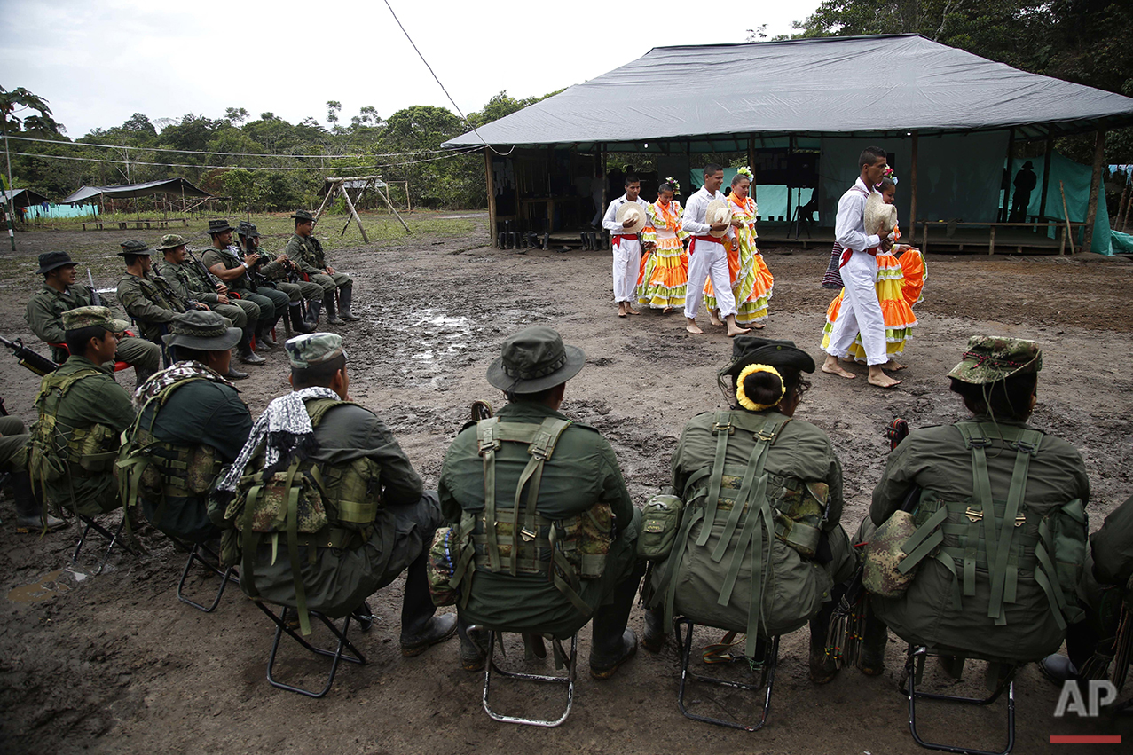  In this Aug. 11, 2016 photo, rebels of the the 32nd Front of the Revolutionary Armed Forces of Colombia perform folk dances in front of their comrades at their camp in the southern jungles of Putumayo, Colombia. The FARC's southern bloc, to which th