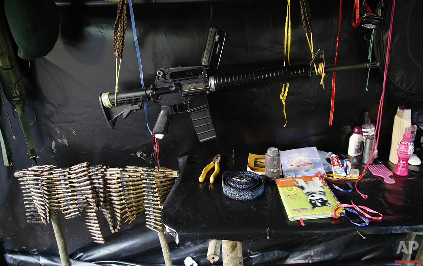 In this Aug. 11, 2016 photo, an assault rifle hangs in the tent of the 48th Front of the Revolutionary Armed Forces of Colombia, or FARC, in the southern jungles of Putumayo, Colombia. The FARC's southern bloc is one of the rebel army's oldest and m
