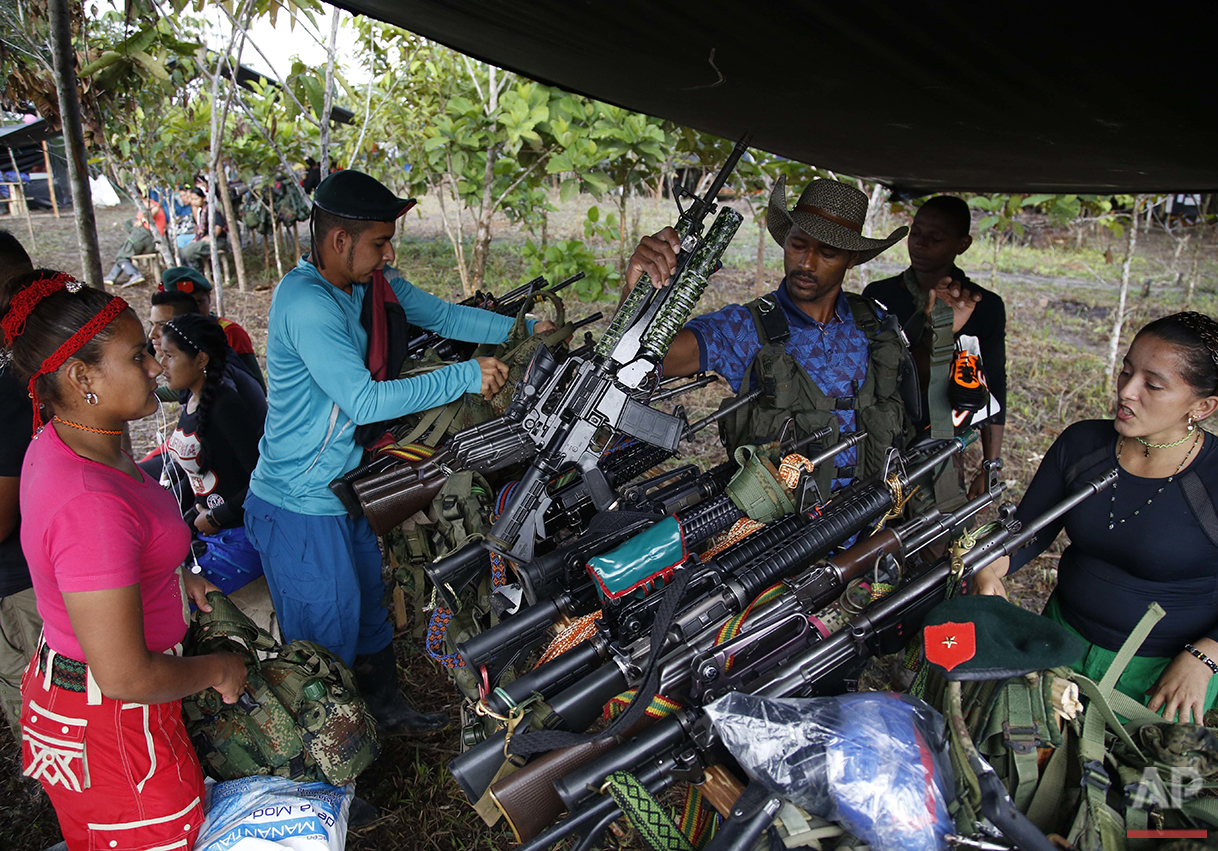  In this Aug. 11, 2016 photo, rebels of the 48th Front of the Revolutionary Armed Forces of Colombia, check-in their weapons before the start of a soccer tournament in the southern jungles of Putumayo, Colombia. The rebels stacked their weapons as re