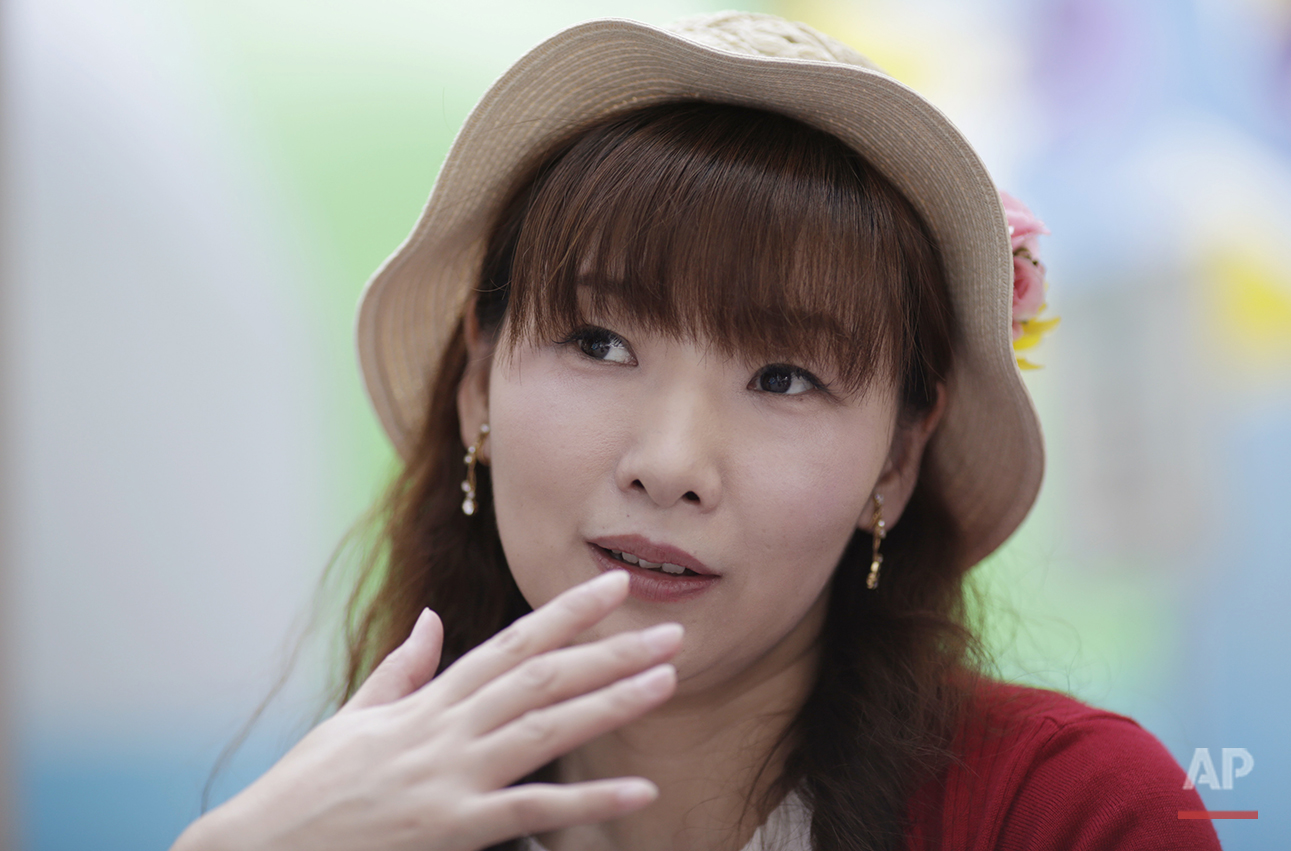  Ayumi Takeoka, 41, homemaker, attends a summer fair held by a television station in downtown Tokyo on Friday, July 29, 2016. She says her image of America is positive, citing President Barack Obama's visit to Hiroshima. "I was delighted to see Obama