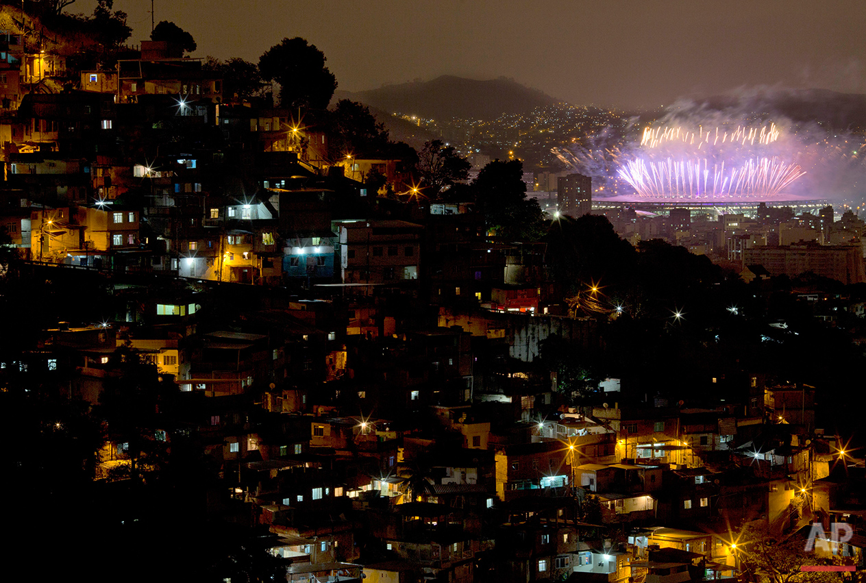  With the Morro dos Prazeres slum in the foreground, fireworks explode over the Maracana stadium during the closing ceremony of the 2016 Summer Olympic Games in Rio de Janeiro, Brazil, Sunday Aug. 21, 2016.(AP Photo/Leo Correa) 