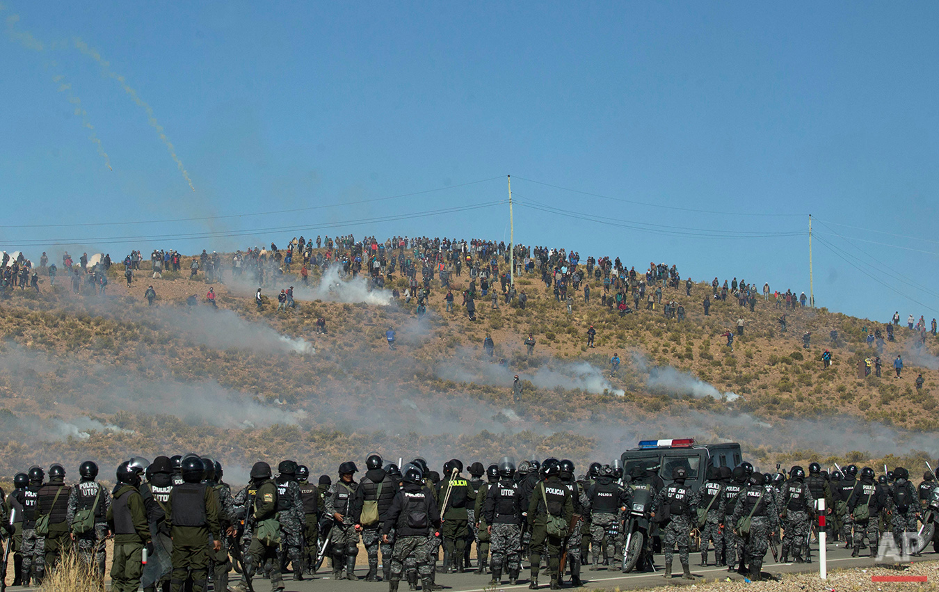  Independent miners, above, clash with the police as they run from clouds of tear gas during protests in Panduro, Bolivia, Thursday, Aug. 25, 2016. Thousands of miners continued their roadblock protests which precipitated the clashes as the police at