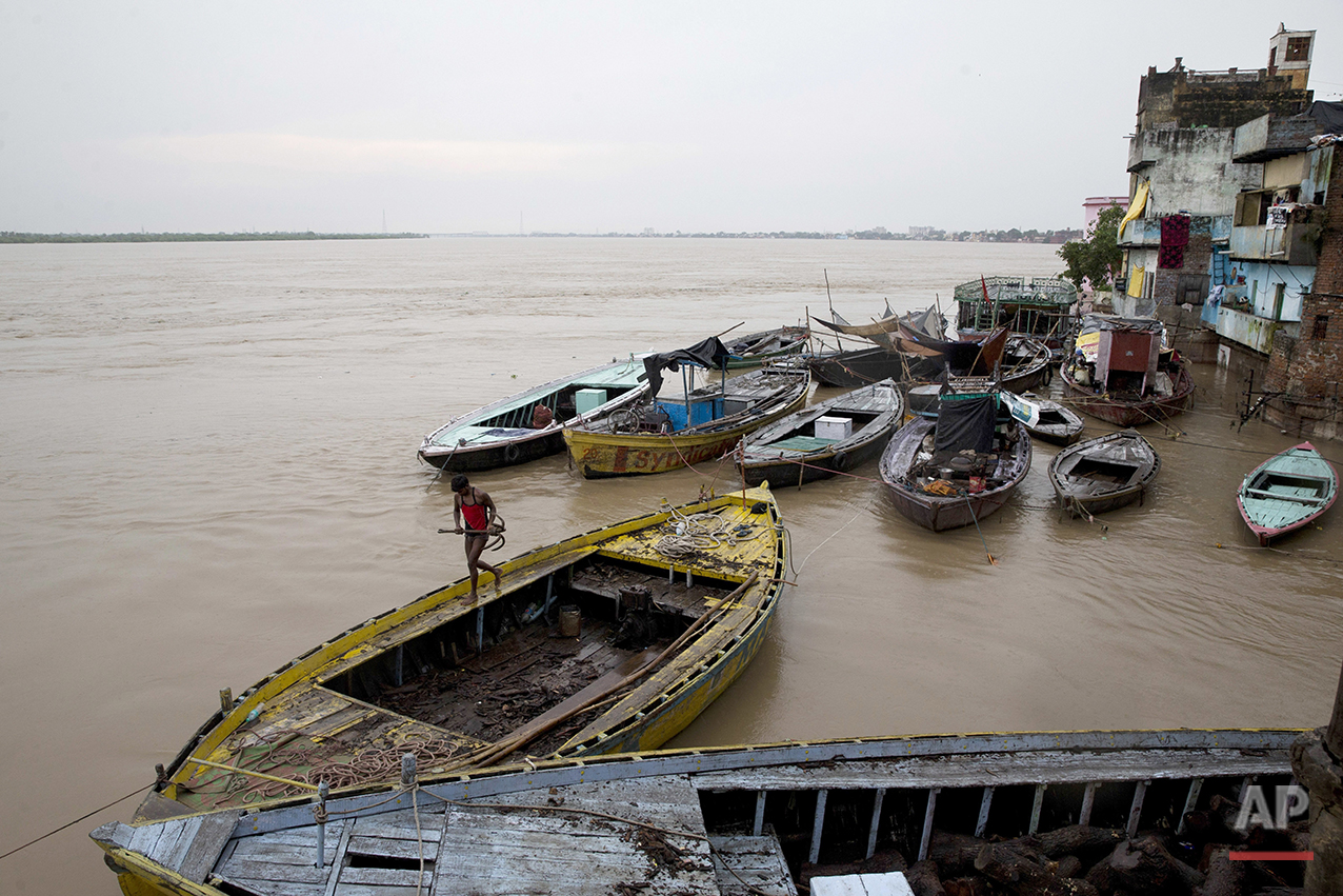  In this Friday, Aug. 26, 2016 photo, boats are docked at the Manikarnika Ghat, submerged by the flood waters in Varanasi, India. As the mighty Ganges River overflowed its banks this past week following heavy monsoon rains, large parts of the Hindu h