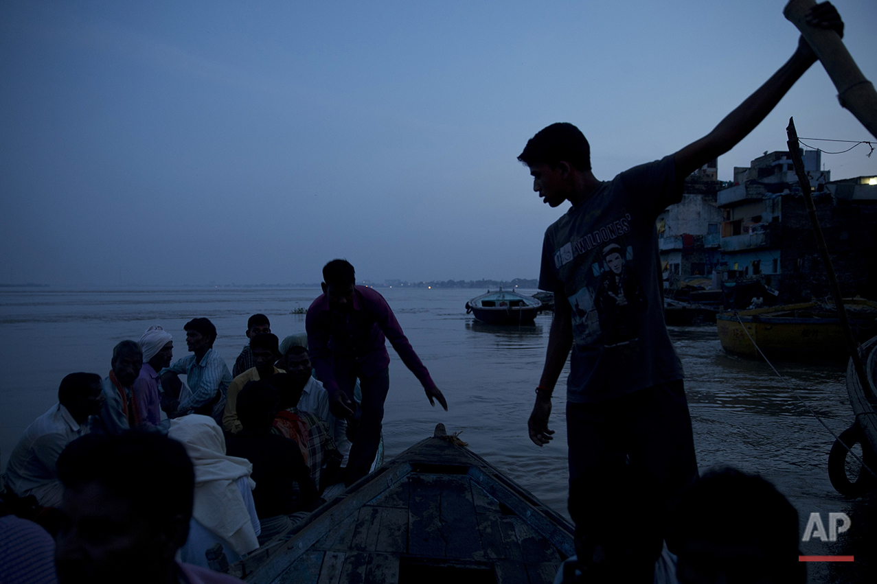  In this Thursday, Aug. 25, 2016 photo, Hindu mourners sit on a boat at the Manikarnika Ghat, on the banks of the Ganges river in Varanasi, India. As the mighty Ganges River overflowed its banks this past week following heavy monsoon rains, large par